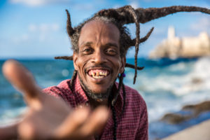 Cuba, Havanna, El Demonio, cheerful man with dreadlocks on the beach, gestures Cuba, Havanna, El Demonio, cheerful man with dreadlocks on the beach, gestures